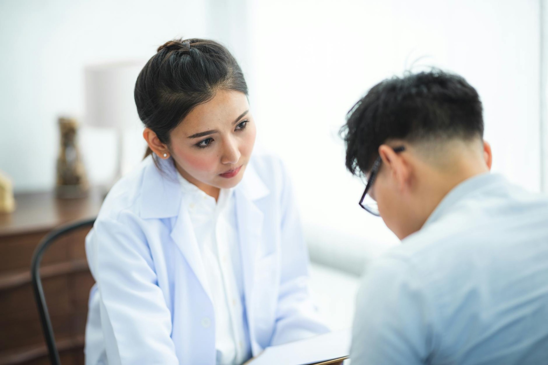 Female doctor attentively listening to patient during consultation